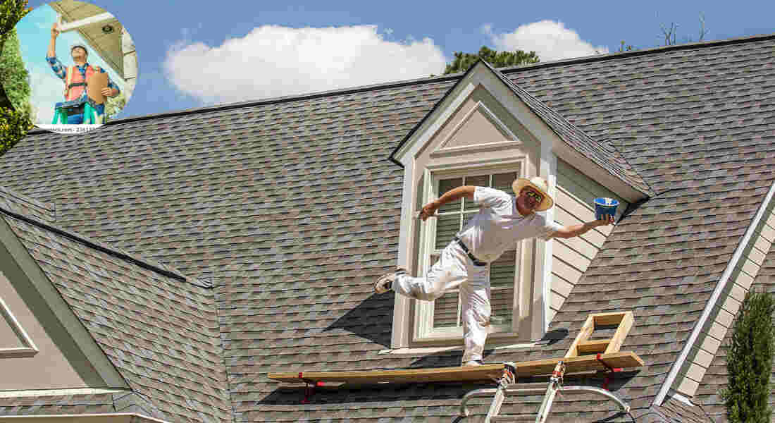 a man standing on the roof of a house